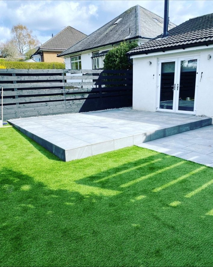 Giffnock finished garden with raised paved patio and lawn